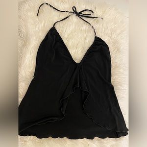 Flirty open flutter front top. Tie and adjusts at neck.